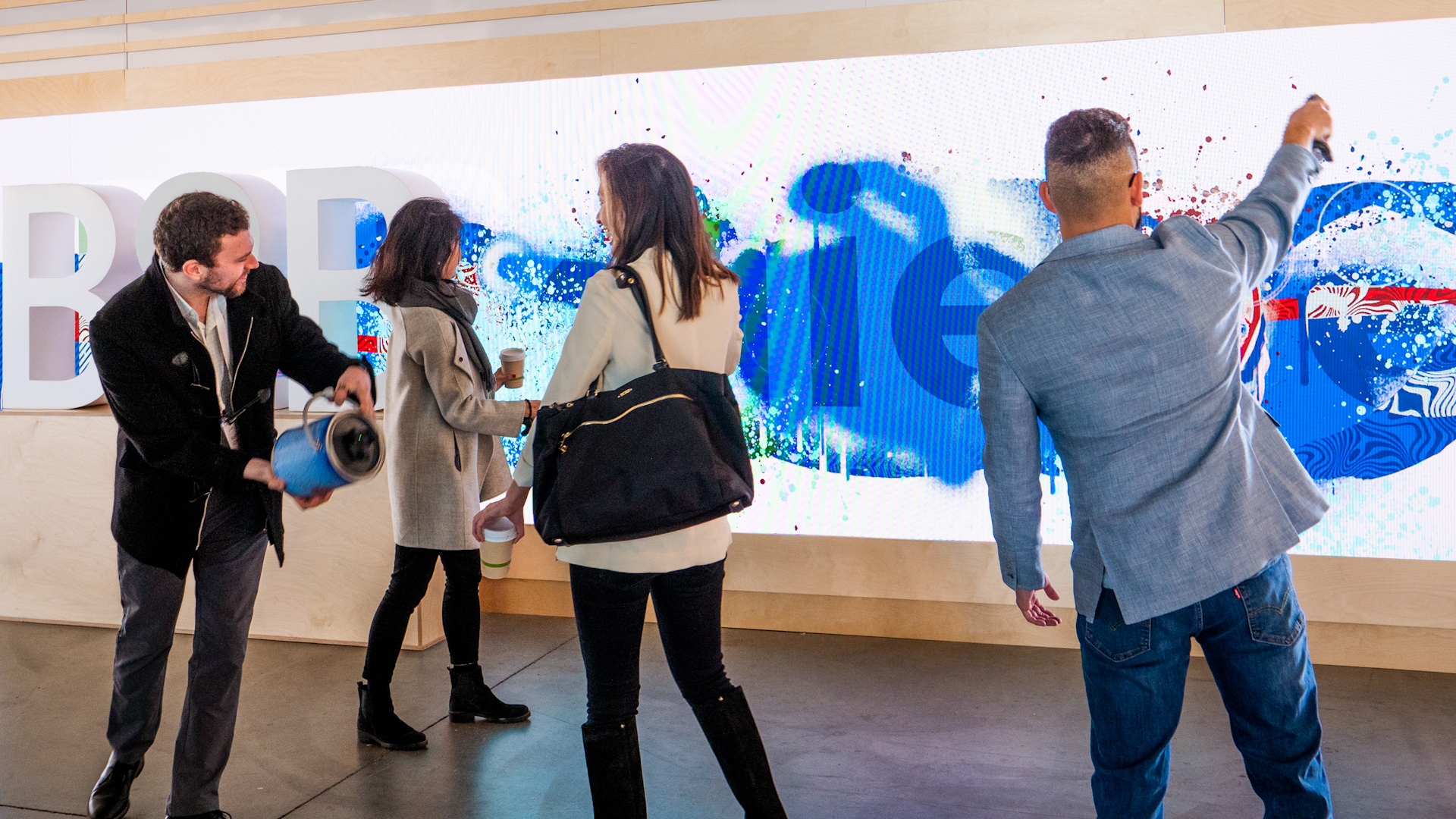 People interacting with the digital graffiti wall.